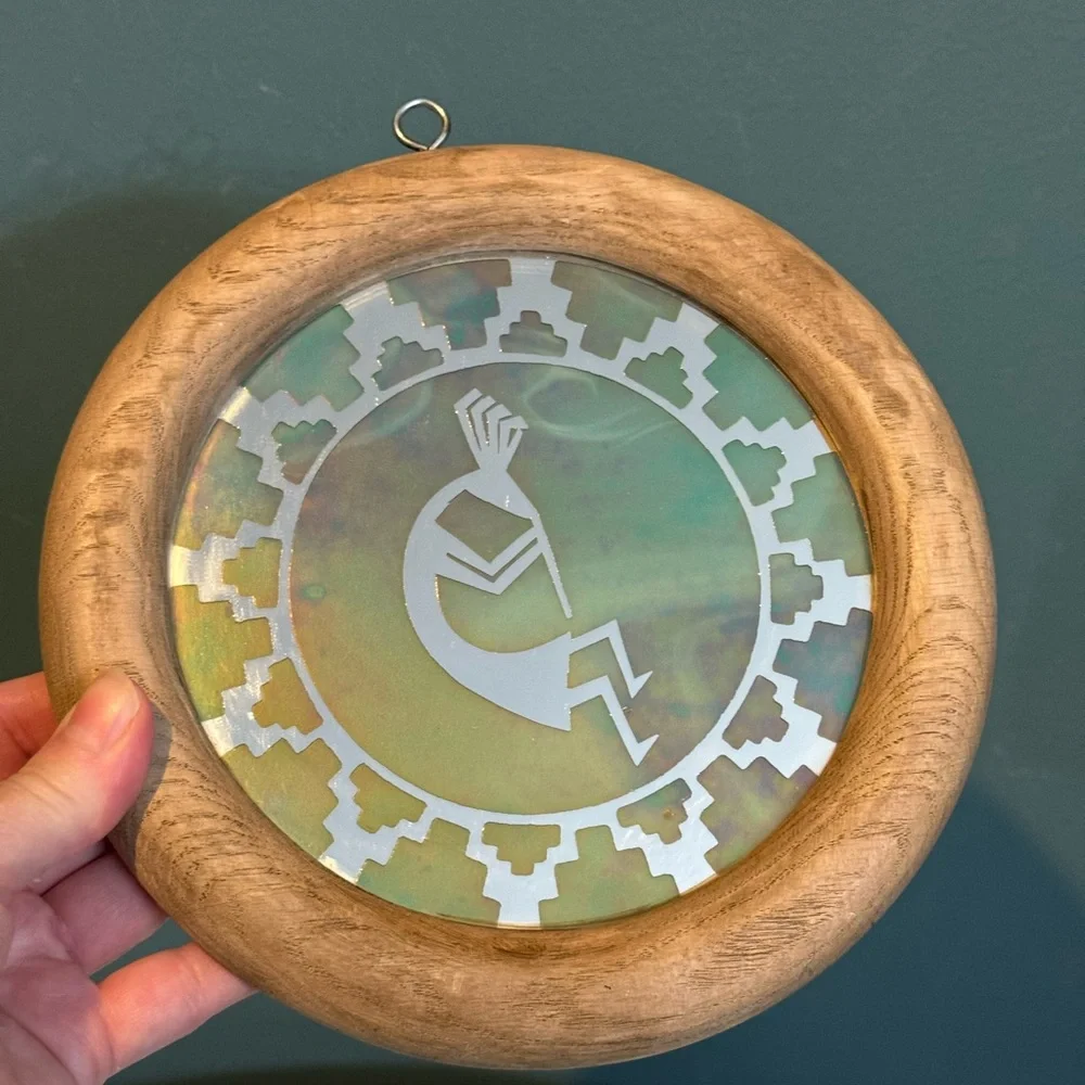 Kokopelli wall mirror with iridescent overlay in wooden frame - 7.75” diameter